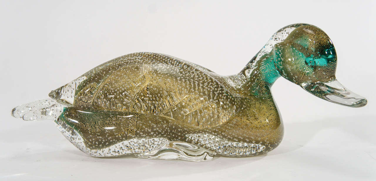 The perfect Murano sculptural centerpiece, decorative element or charming decoration, this large green hand blown duck was made by Barbini. Sure to make you smile, he is filled with controlled bubbles, gold leaf inclusions and cased in clear
