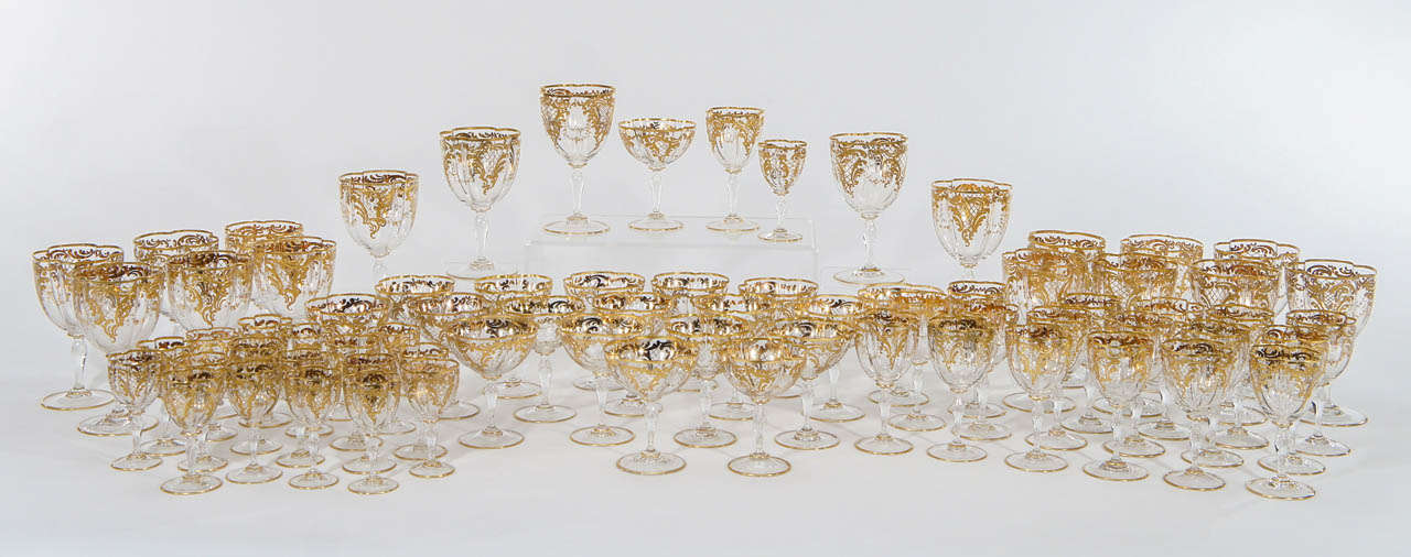 An amazingly complete service for 12- hand blown crystal stemware with quatrefoil shaped bowls, each one embellished with raised paste gold enamel decoration in an Art Nouveau style.
The elegant service is perfect for today's table as each size is