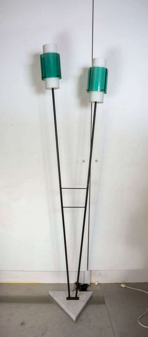 Floor lamp with two lights on marble base.