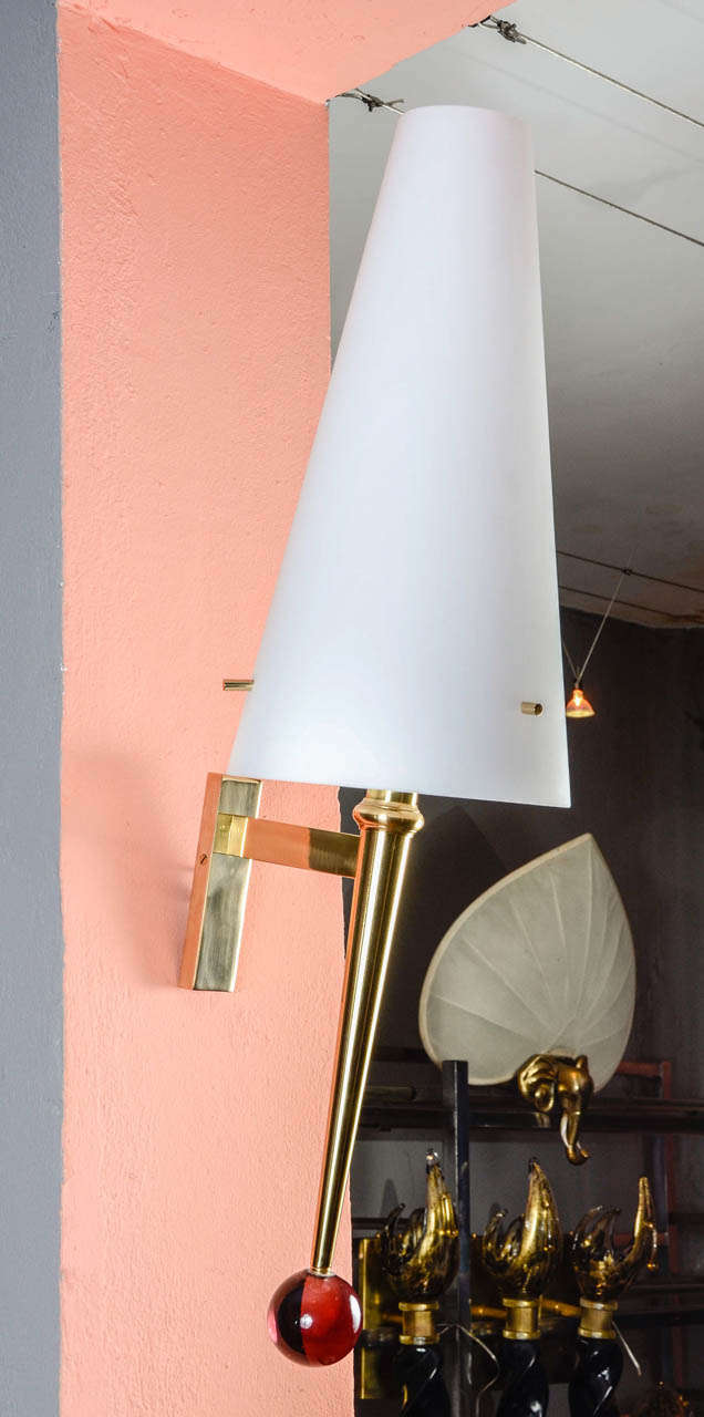 Pair of sconces in brass with glass shade.