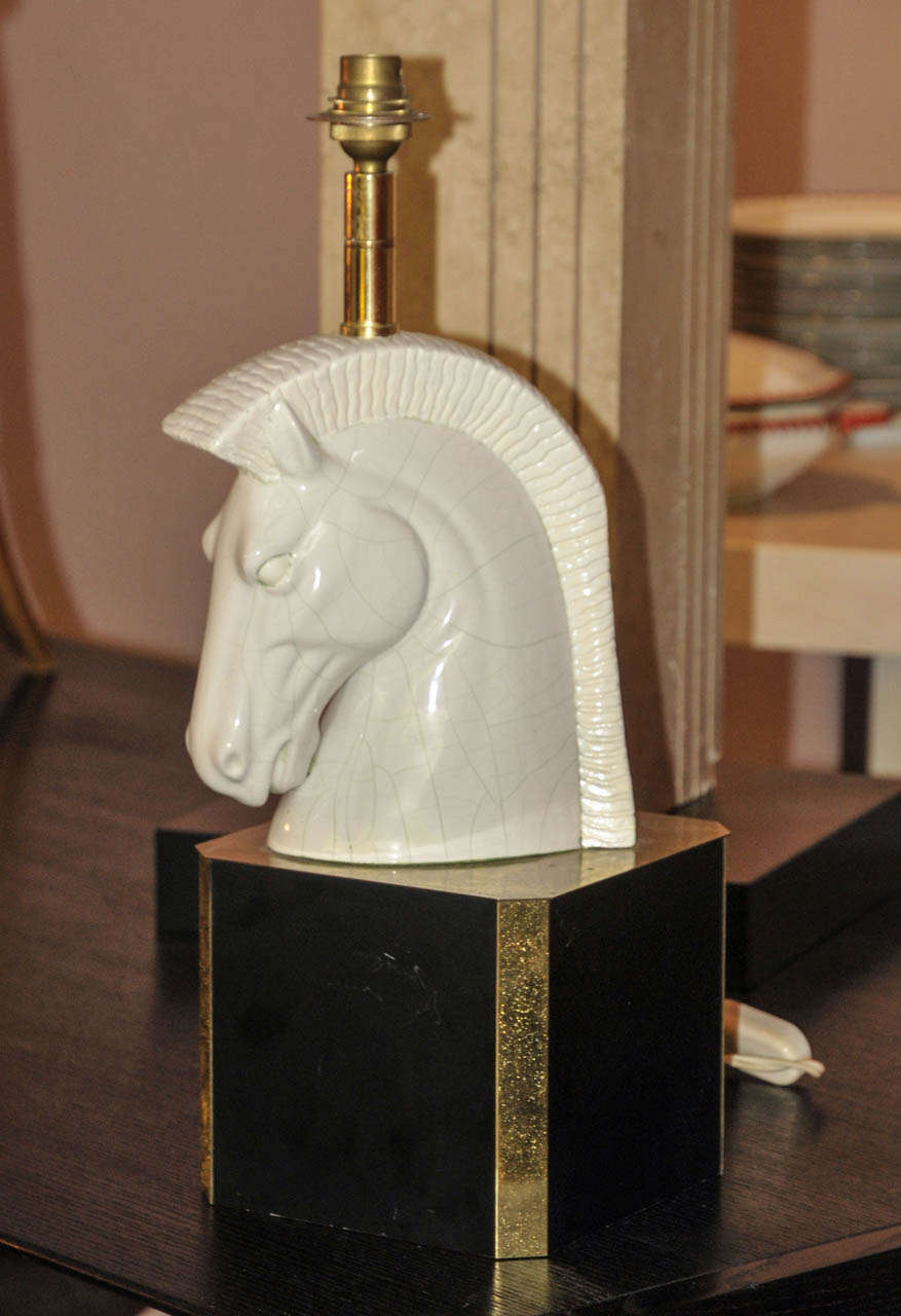 1950's horse ceramic table lamp. Black lacquered and gilded brass base. Wired for European use.  Good condition. Normal wear consistent with age and use.