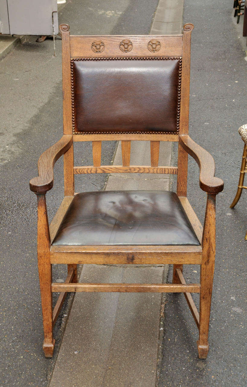 Pair of 1880 armchairs 'Art and Craft' edition. Oak and leather imitation. Good condition. Normal wear consistent with age and use.