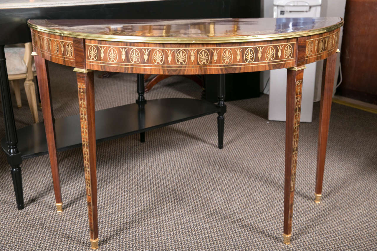 Pair Russian Neoclassical Rosewood Inlaid Demi lune Console Tables. This fine pair of 19th Century Russian Neoclassical Demi Lune Consoles depict the times and style of the era wonderfully. The finely tapered legs standing on bronze sabots with leaf