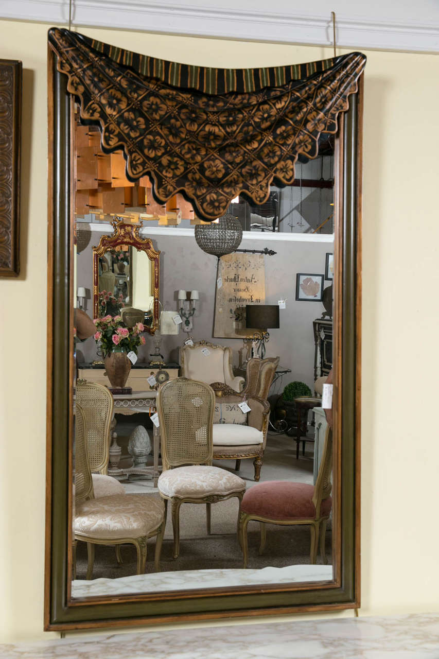 Dorothy draper style drapey form mirror. This highly decorative mirror would look spectacular in any room setting. The hand-painted rosettes and decorative upper drapery over a center mirror framed in a greenish and gold tone surround.