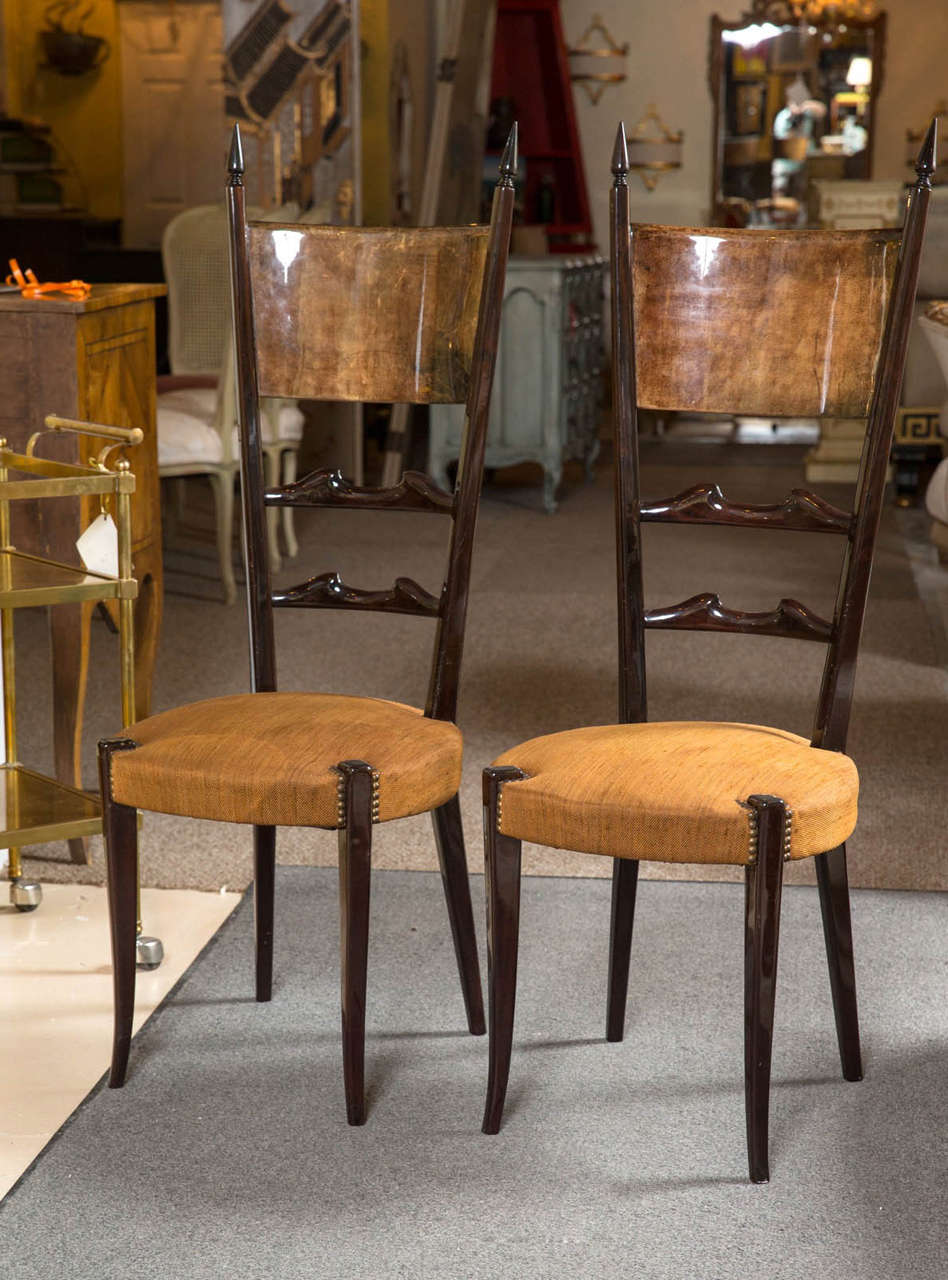 Set of Four Aldo Tura Hi Back Side Chairs. Italian design at it's best are seen in these four wonderfully decorated high back chairs.  All four are adorned with the distinctive Tura goat skin signature and a soft faded yellow upholstery.  Extremely