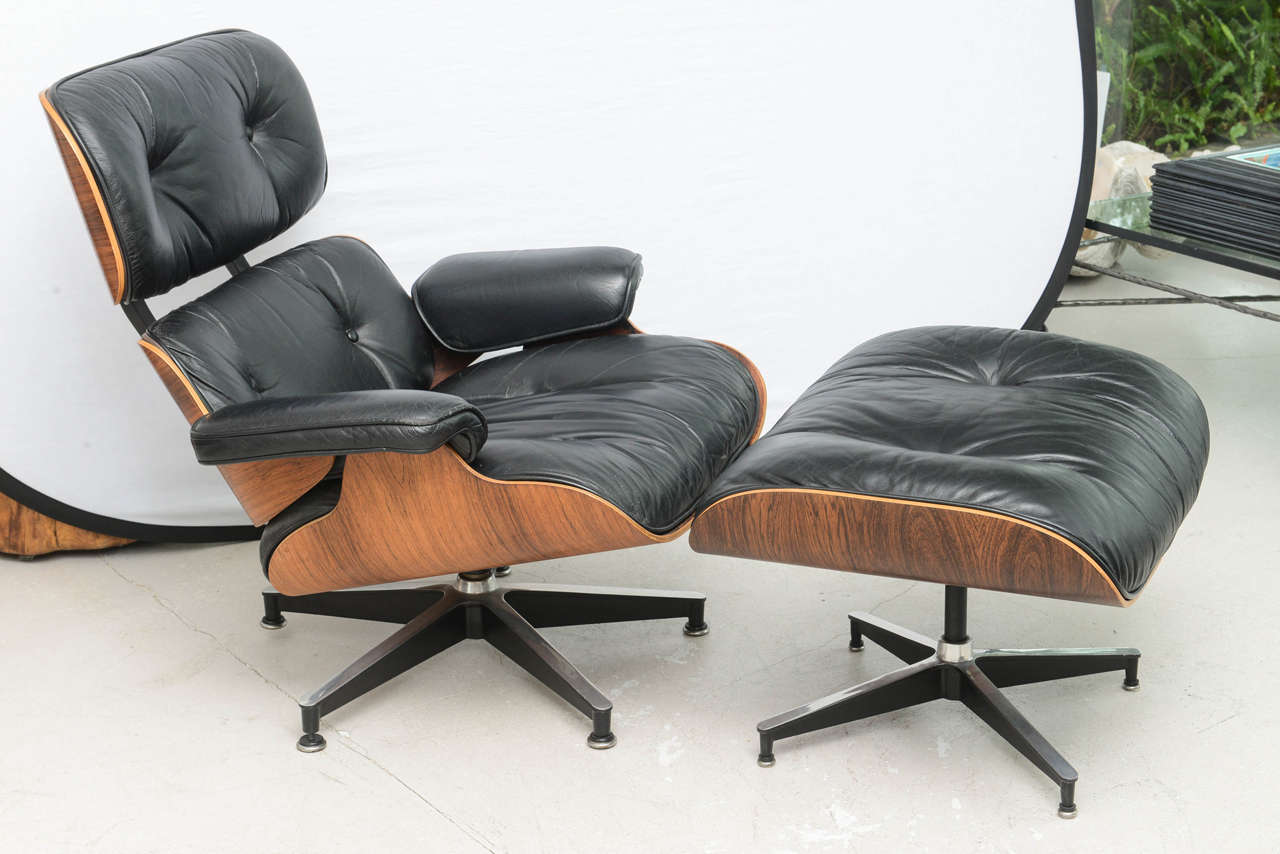 Two individually priced vintage Eames rosewood and black leather with matching ottoman. Each ottoman measures: 17 H x 26 W x 32 D.