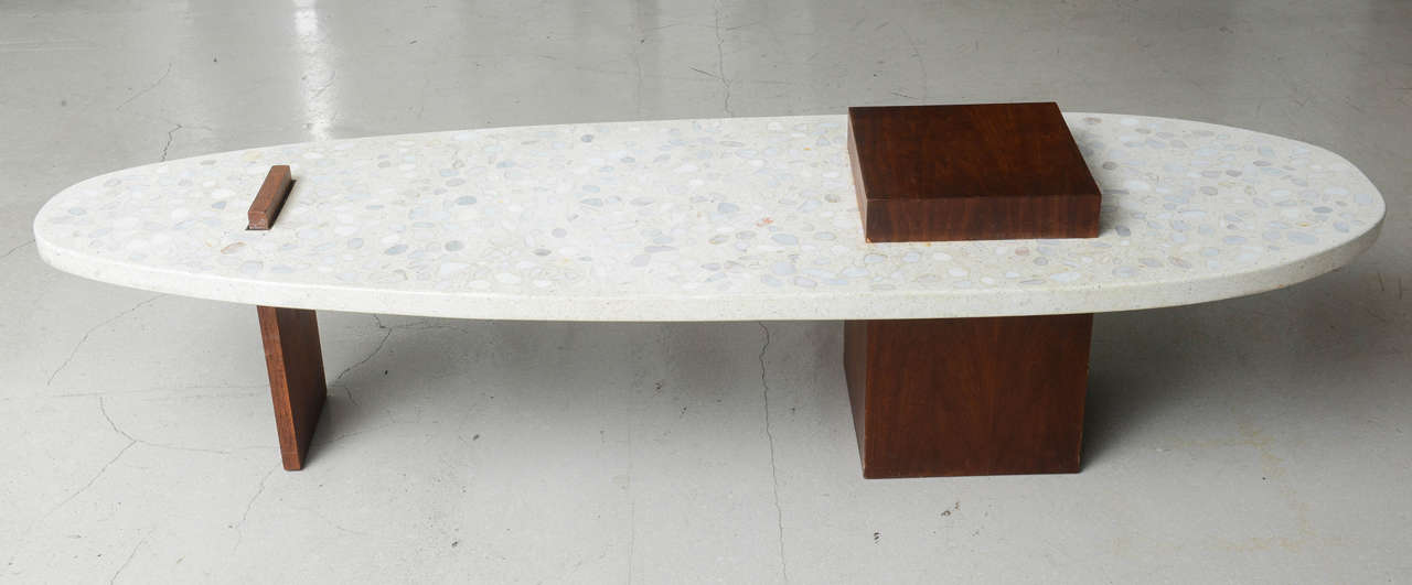 Long surf board styled coffee table with terrazzo top and intersecting walnut design. We also offer the coordinating occasional table sold separately.