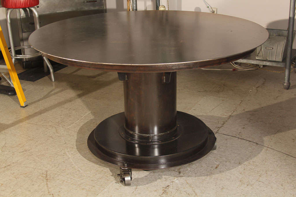 Made to order, industrial, steel table, made from salvage materials.  Perfect for display, and dining.  Casters added.  Contact Dealer for specific details.