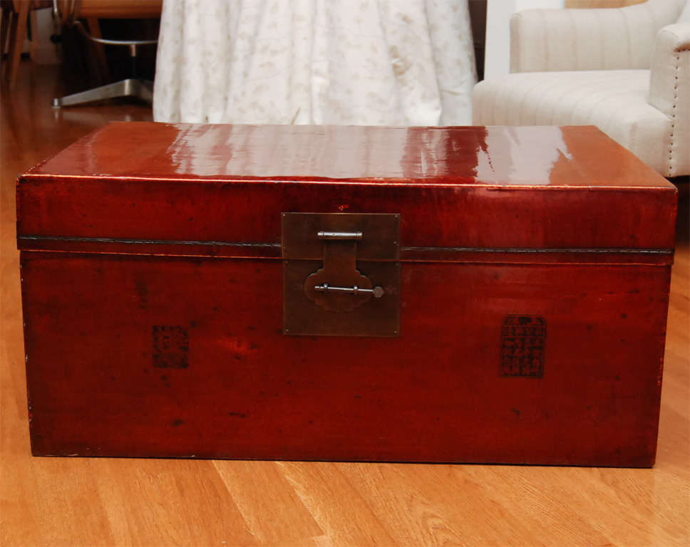 Large red lacquered vellum box with Chinese script on the front. Brass latch, pin and bail handles. A truly wonderful piece!