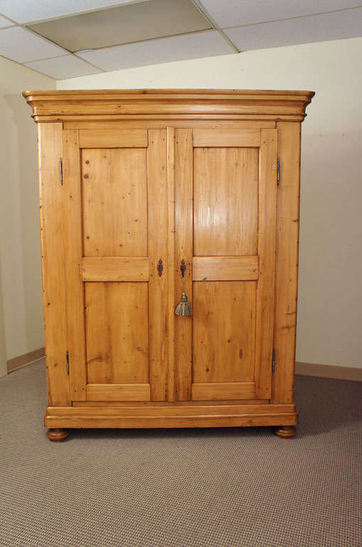 A two door pine armoire of attractive blond colour featuring all pegged construction and a complete knock-down facility that makes it easy to transport and install in any location.
