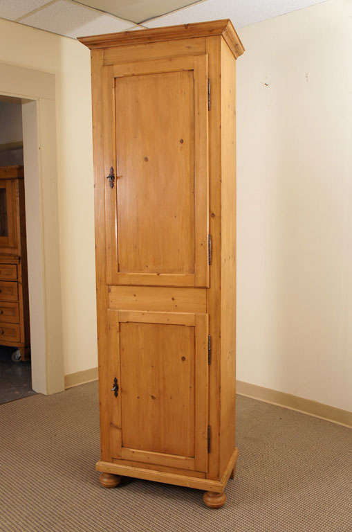 A plain and functional chimney cupboard featuring two panelled doors, the frames delicately chamfered, opening 180 degrees on original fiche hinges, to reveal a single shelf in each section, fully adjustable on original wooden sawtooth track.