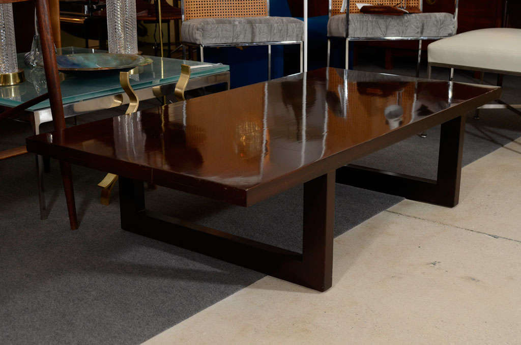 Bold mahogany coffee table by Edward Wormley for Dunbar.  USA, circa 1950.  Signed with Dunbar tag.  U-shaped legs supporting a rectangular top.  .
