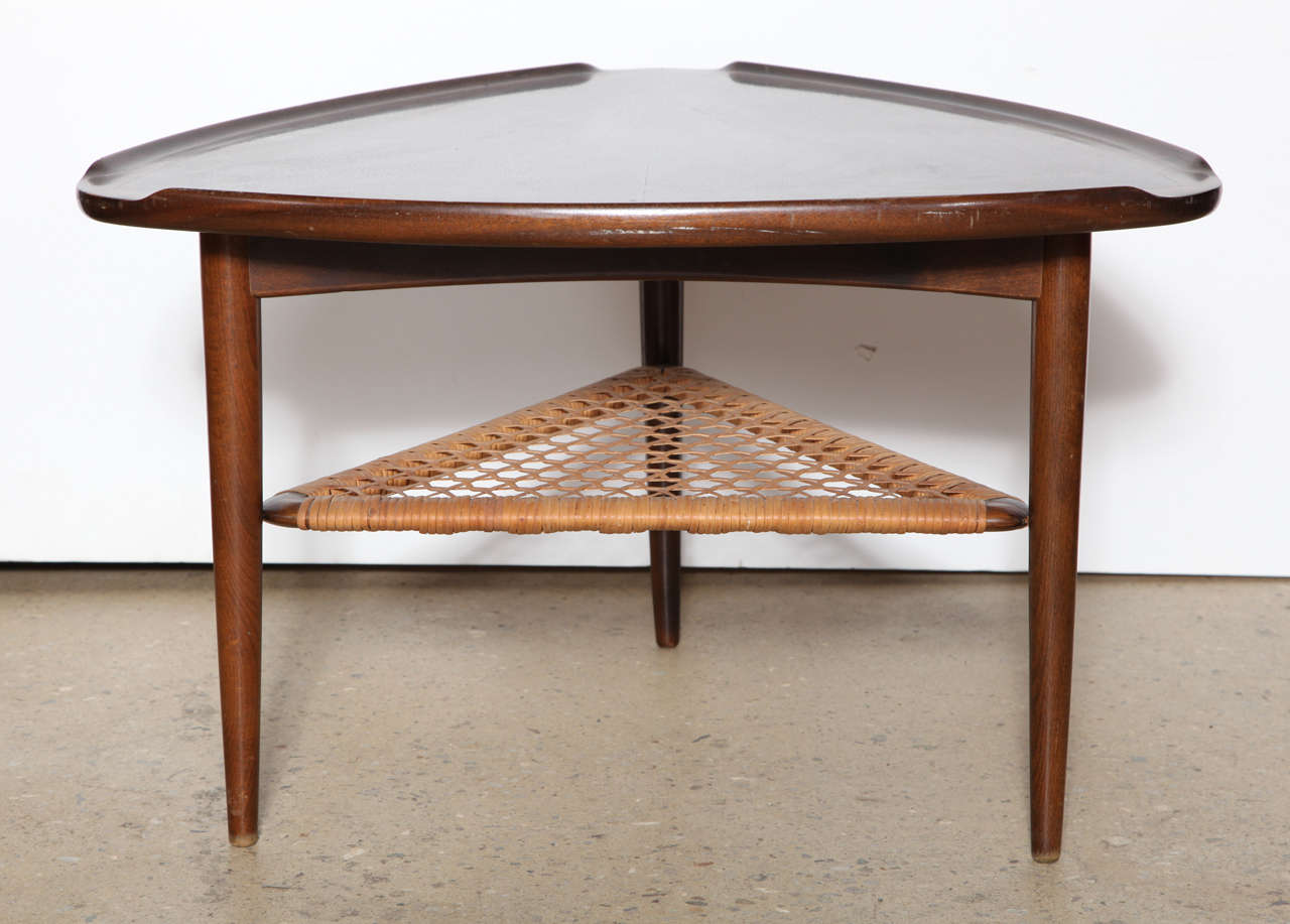 Triangular guitar pick shaped Table by Poul Jensen.  Beautiful Walnut grain on top with Teak legs and woven caned lower shelf.  Made in Denmark, manufactured by Selig. Great as a Coffee Table, Side Table or End Table