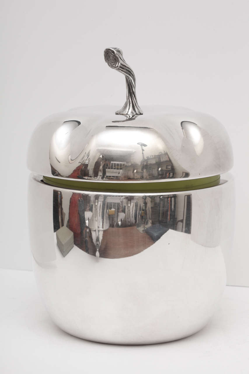 Novelty ice bucket in the shape of an apple. Silver plated metal with a removable apple green colored plastic liner.  Apple has a twisted stem and sculpted lid. A large and impressive item which is quite the conversation piece. Original Hoka label