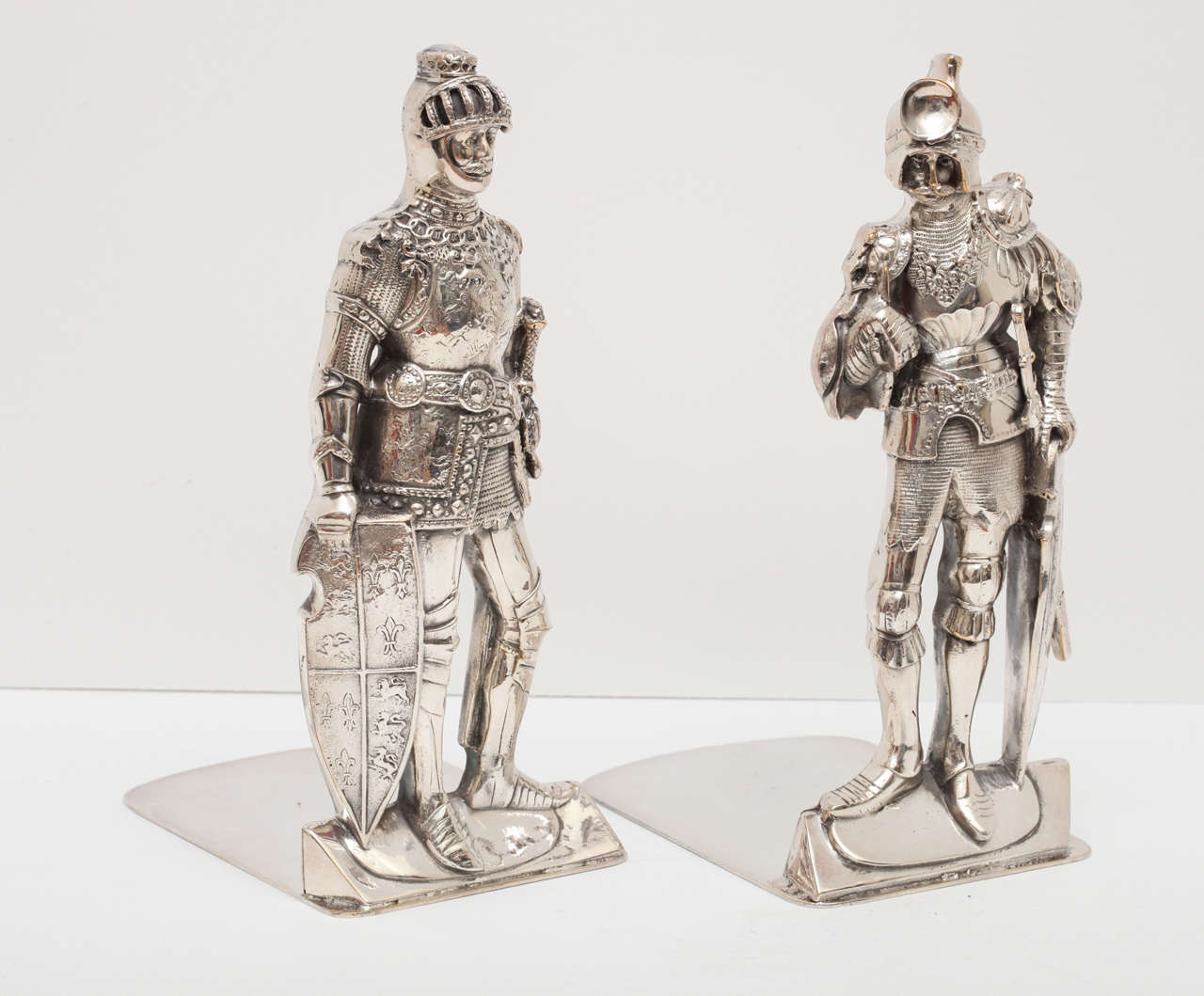 Beautifully detailed pair of silver plated medieval knight bookends. They are highly unusual and quite interesting as they are not an identical pair which denotes the quality as they are not cast once and replicated.  They have a maker's mark in the