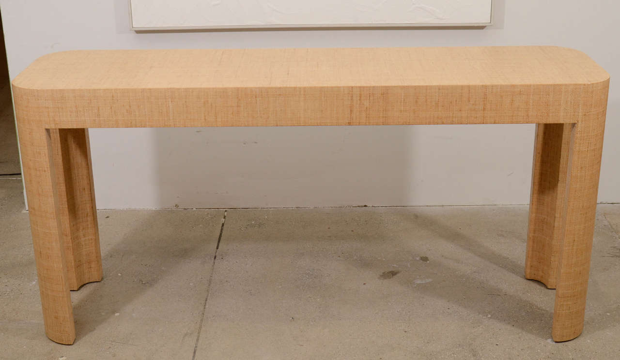 Karl Springer lacquered natural toned raffia console table with semi-circular legs and corners.

