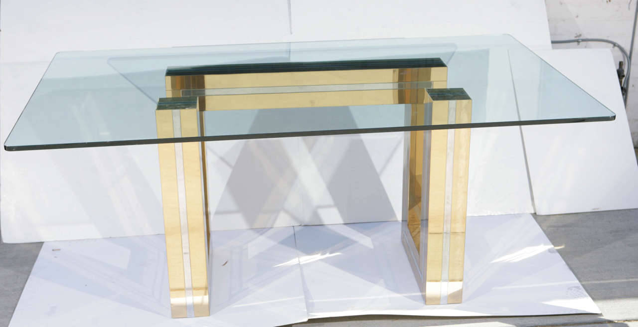 Geometric brass & chrome base dining table with glass top attributed to Paul Evans