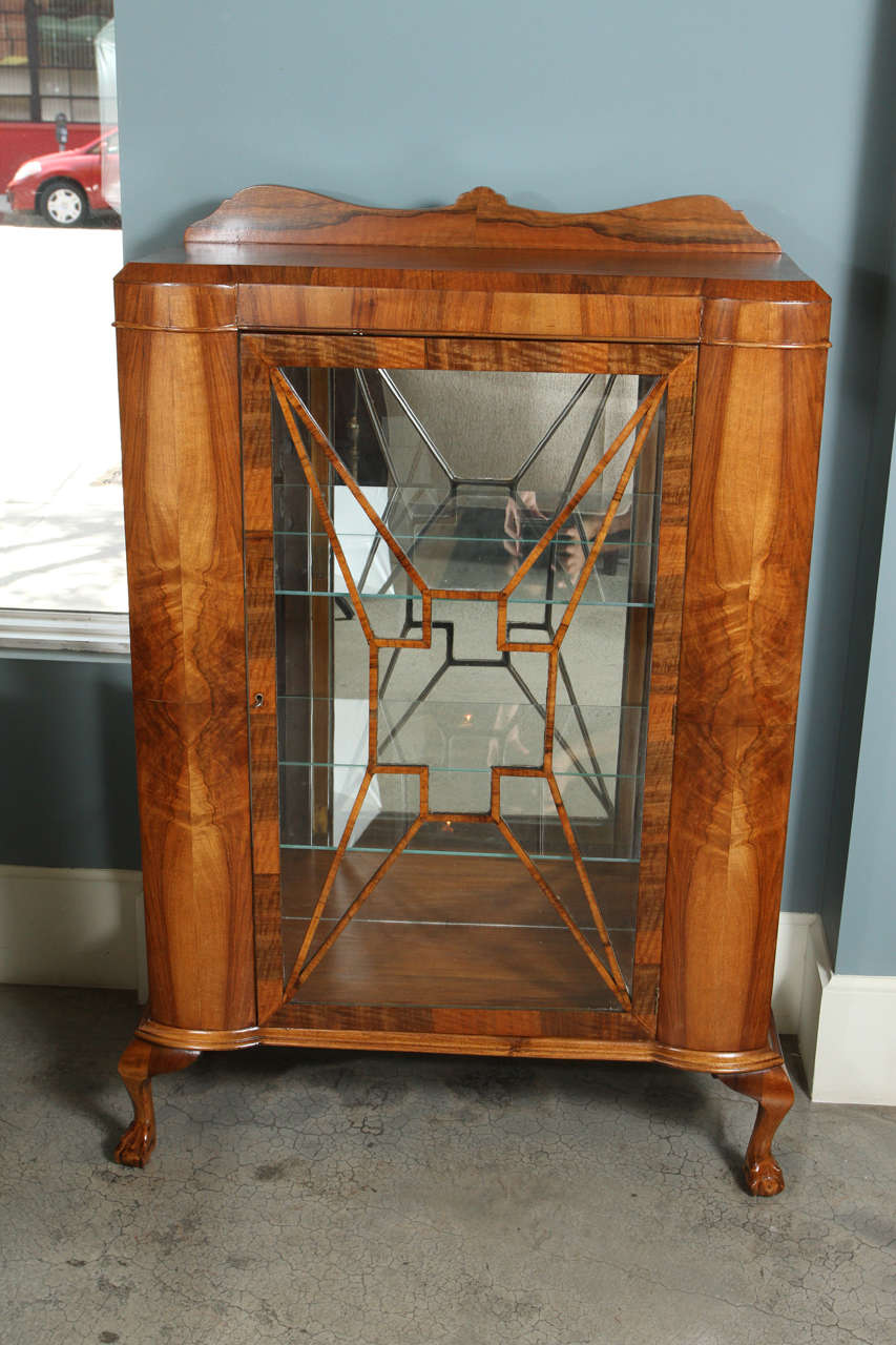 1930's Art Deco China Cabinet with Chippendale Feet. Burl walnut with new glass shelves and mirror back.