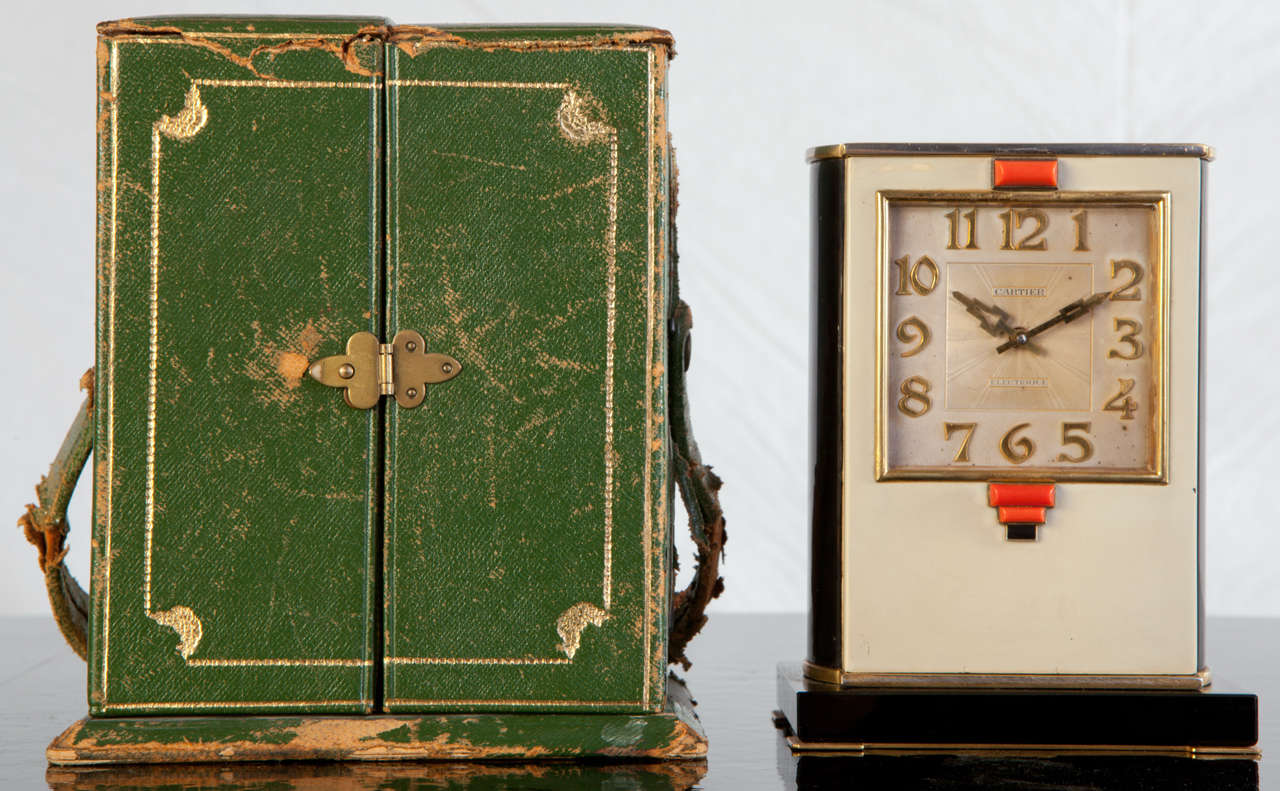 Alarm clock by Cariter ,1928. 
Lacquer, coral, onyx and silver.
Original Box.
Operating on batteries.
