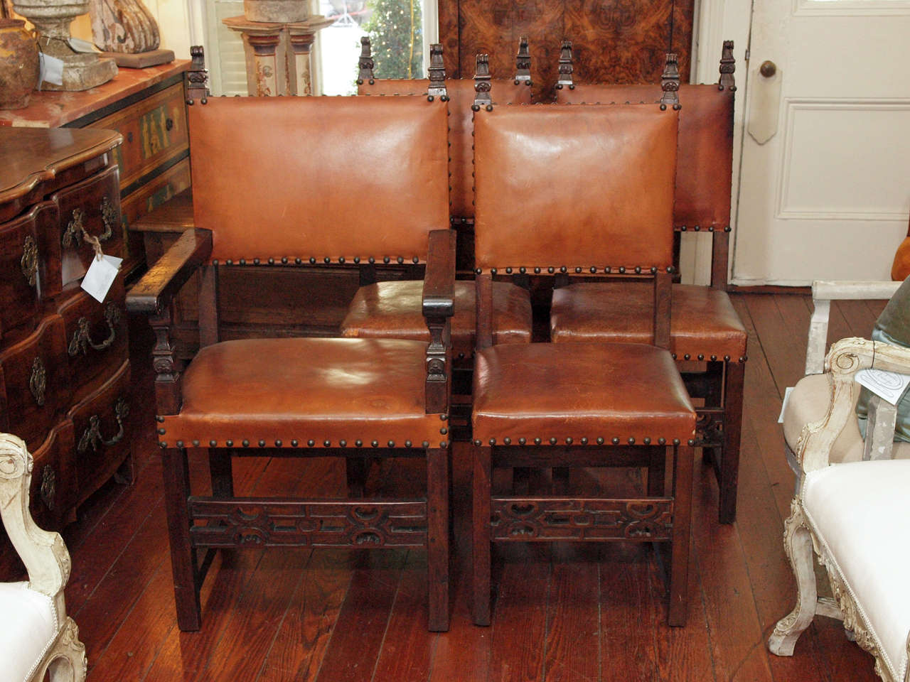 Set of 19th century Spanish walnut and leather dining room chairs. Set includes six chairs and two armchairs.