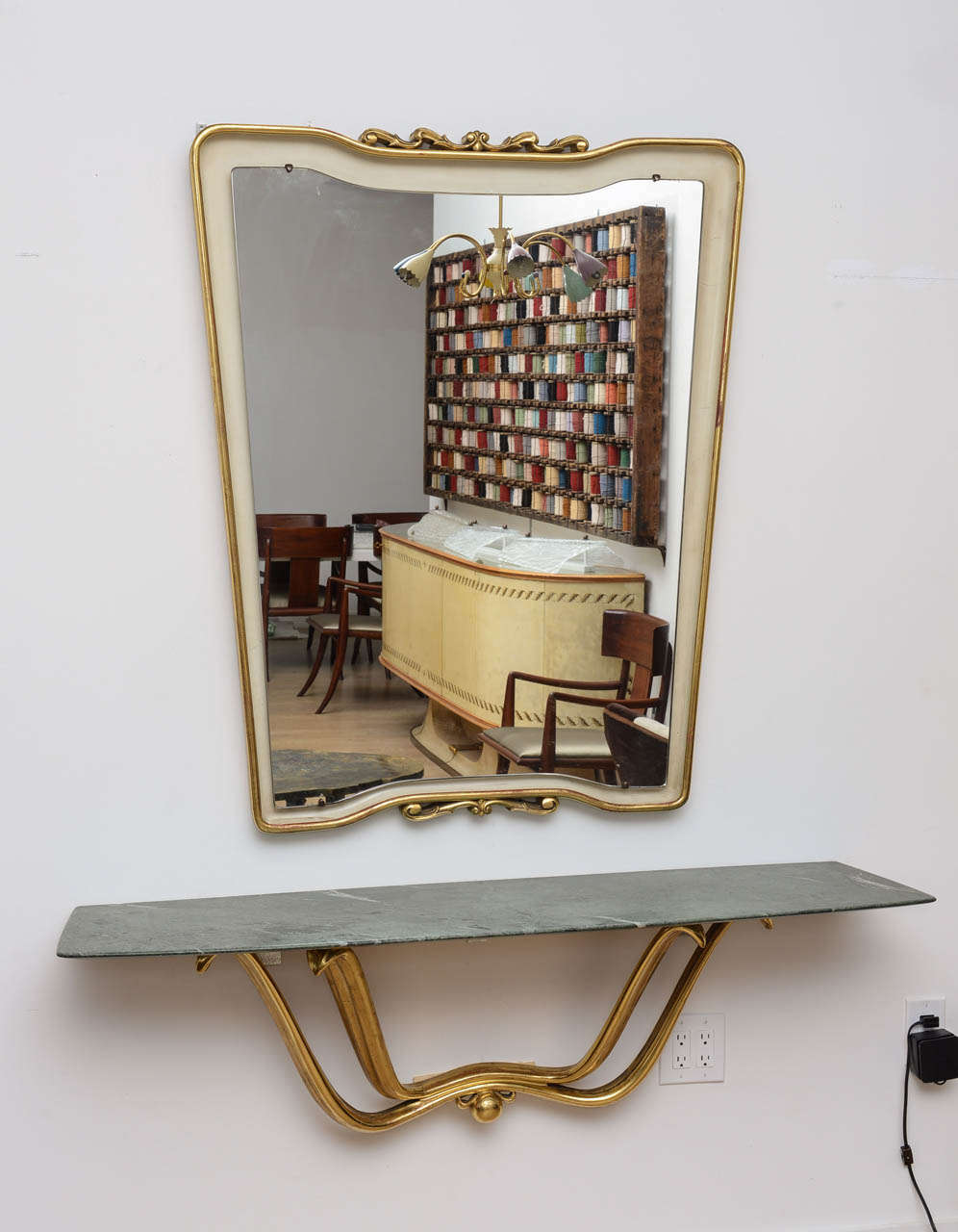 Important set by Osvaldo Borsani comprising of a wall hanging gilt wood console with a green marble top and a matching mirror.
Mirror dimensions are 46
