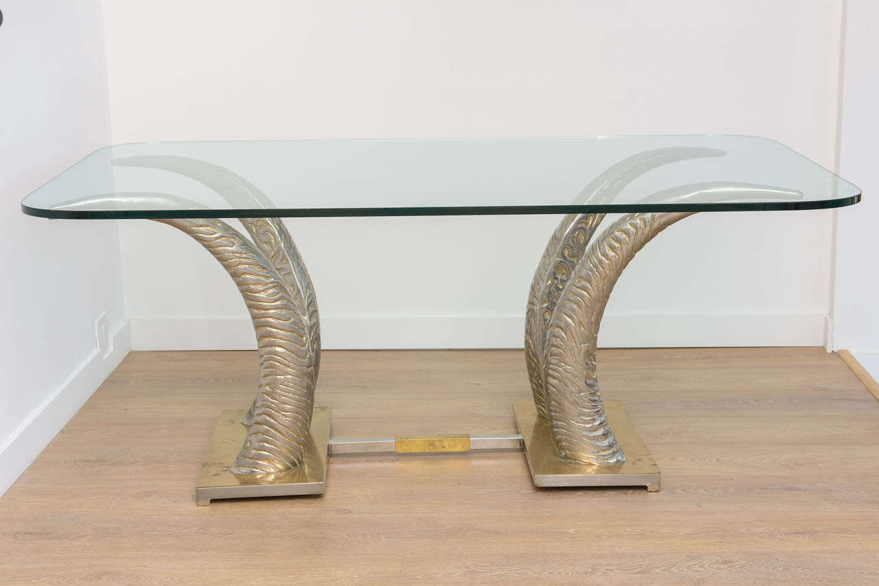 Metal Tusks dining or center table, chrome and brass stretcher.