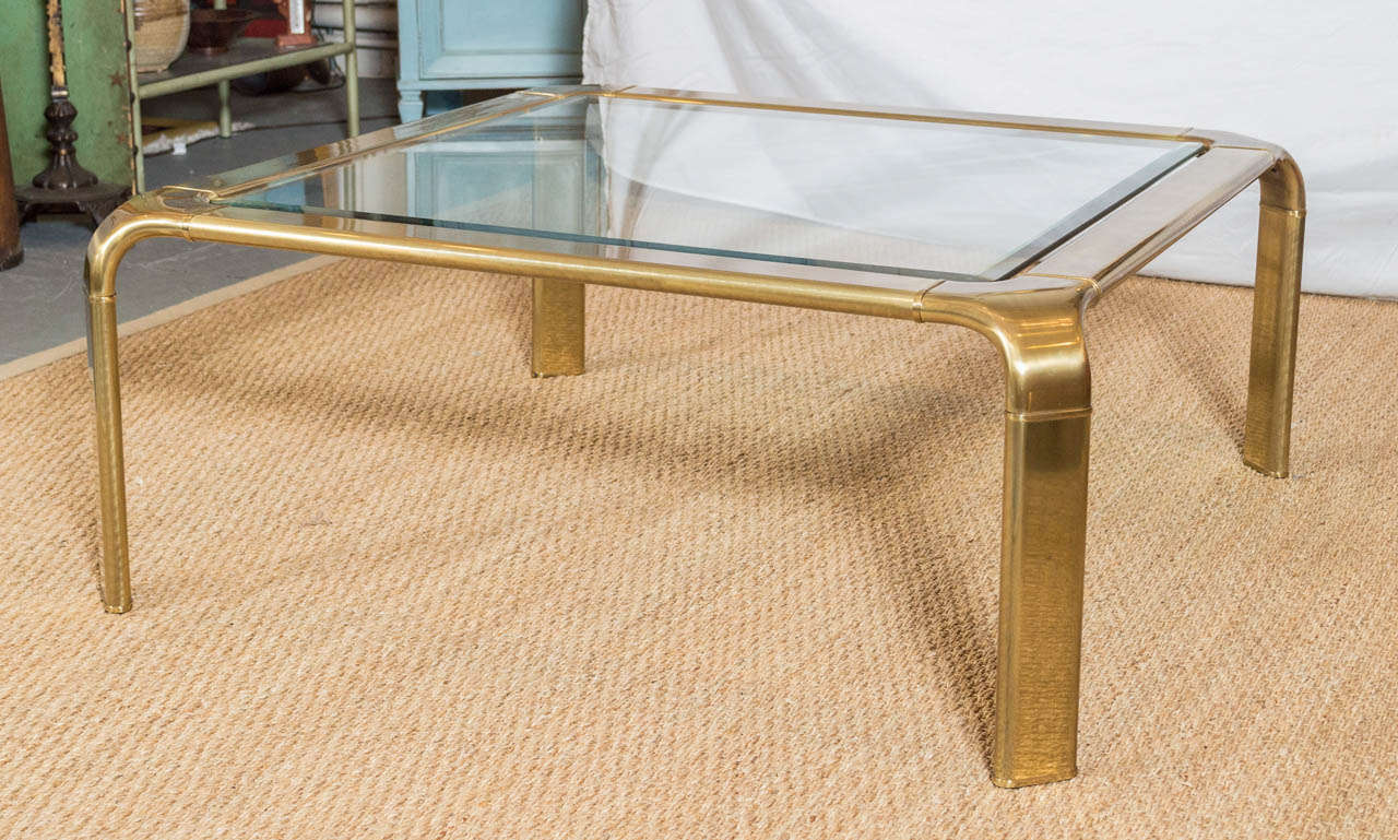 Offering a sexy 1970's coffee table by Mastercraft.  The table is square with a very delicate beveled glass edge.