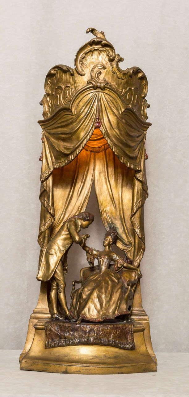 This lamp exemplifies some of the more interesting examples of Vienna bronze work. We have this romantic interlude right before our eyes and it lights up to add even more warmth to the scene. A very unique and rather large example of this genre. It
