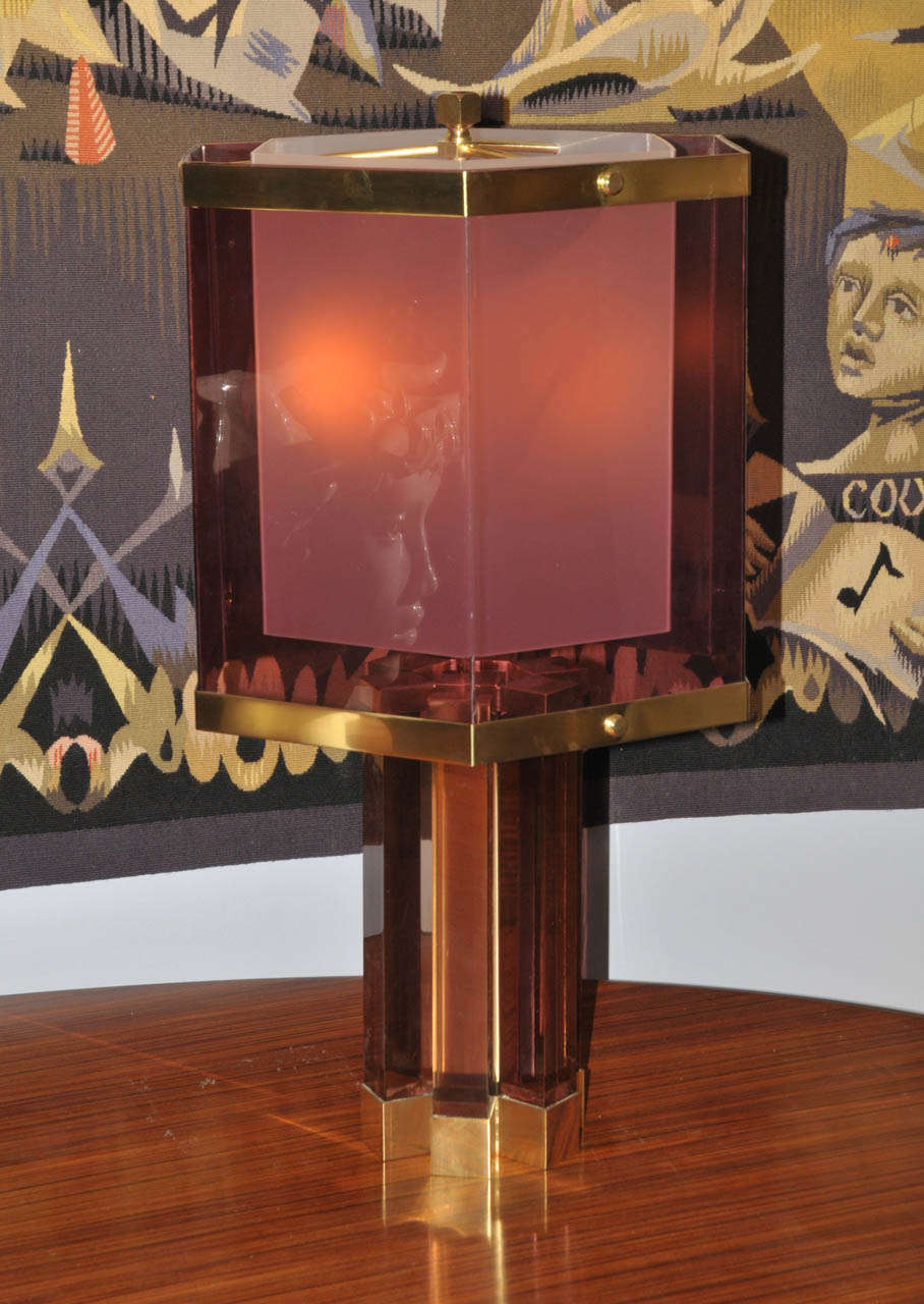 1970's table lamp by Romeo Raga in plexiglass and gilded brass. Two lights. Wired for European use.  Good condition. Normal wear consistent with age and use.