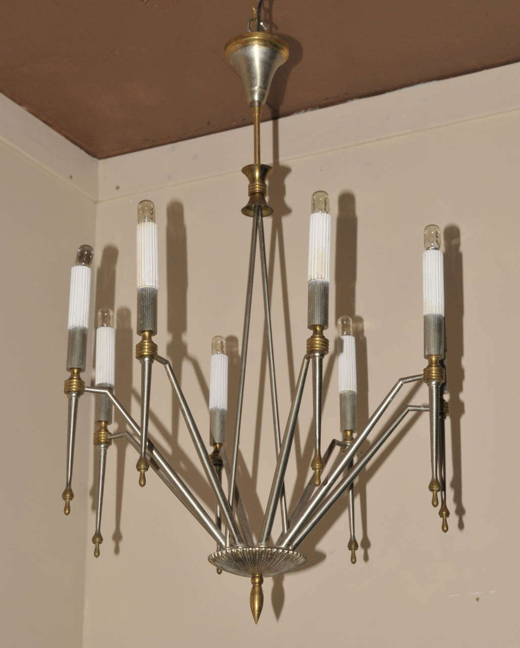 1960's chandelier. Stainless steel and brass. Eight lighted arms. Wired for European use. Good condition. Normal wear consistent with age and use.