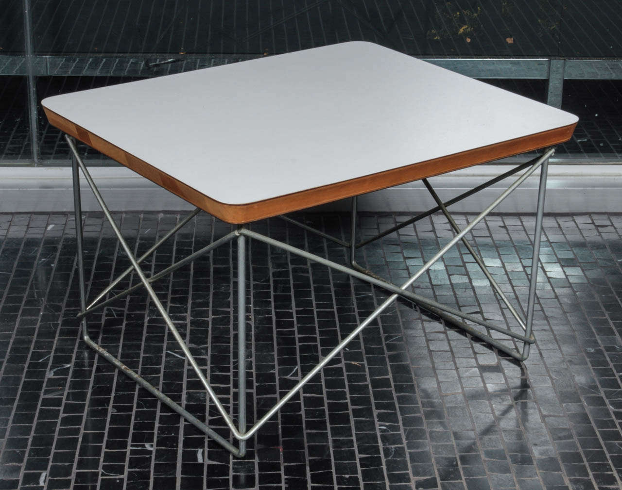 Eames LTR (Low Table Rod) made in the 1950′s. It has a white laminate top with a Herman Miller label underneath and a zinc base.