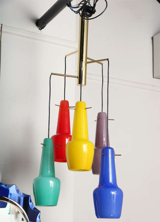 Beautiful five-light chandelier made in Italy designed by Stilnovo.
Five blown cased glass shades hanging from a brass frame. Length of wire is adjustable to whatever length you need.
Beautiful colors. Great fixture.
  