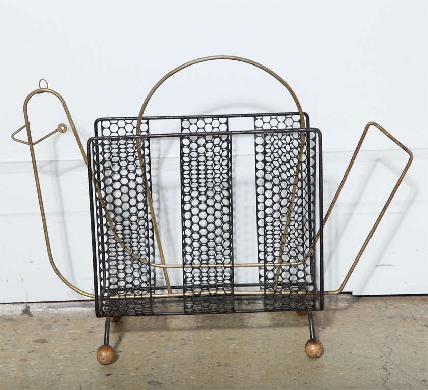 Mid-Century Modern black metal mesh and brass wire abstract chicken, bird form magazine rack with brass handle and round wood ball foot detail. Great accent piece.