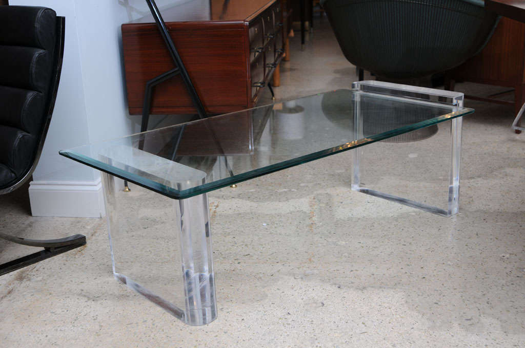 The bevelled glass top fits into a slot on the taller of the two Lucite bases and rests on the lower of the two bases.