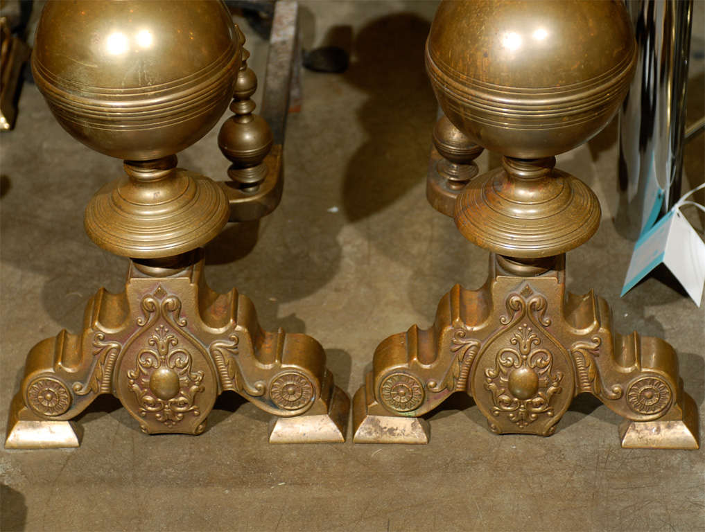 Pair of 19th century large brass andirons with flame finials.