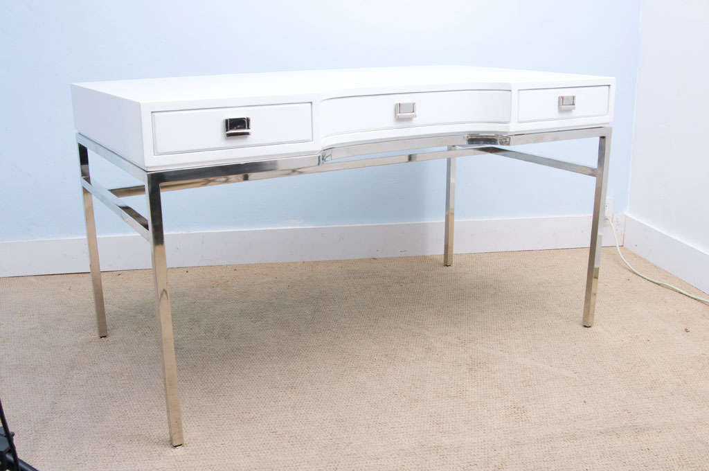 Exquisite 60's white glossy laquered desk, with 3 drawers and stainless steel hardware.
