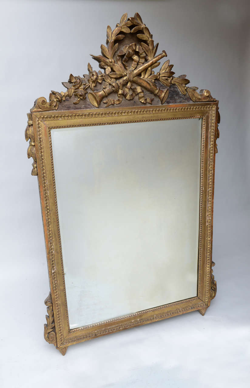 Beautifully carved and gilded neoclassical French mirror.