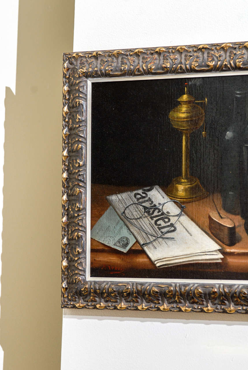 This is a handsome still life.  A newspaper, glass of wine, bottle, lantern are among the items painted.  The artist has signed the painting but unfortunately, it is illegible.  The painting is framed in a two inch carved frame.  The painting was