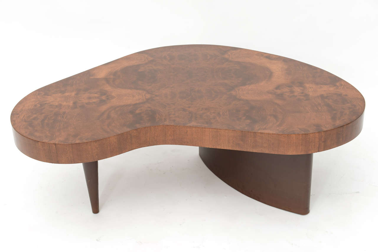 Gibert Rohde biomorphic coffee table.
The wood has been refinished,legs are
wrapped in leather.