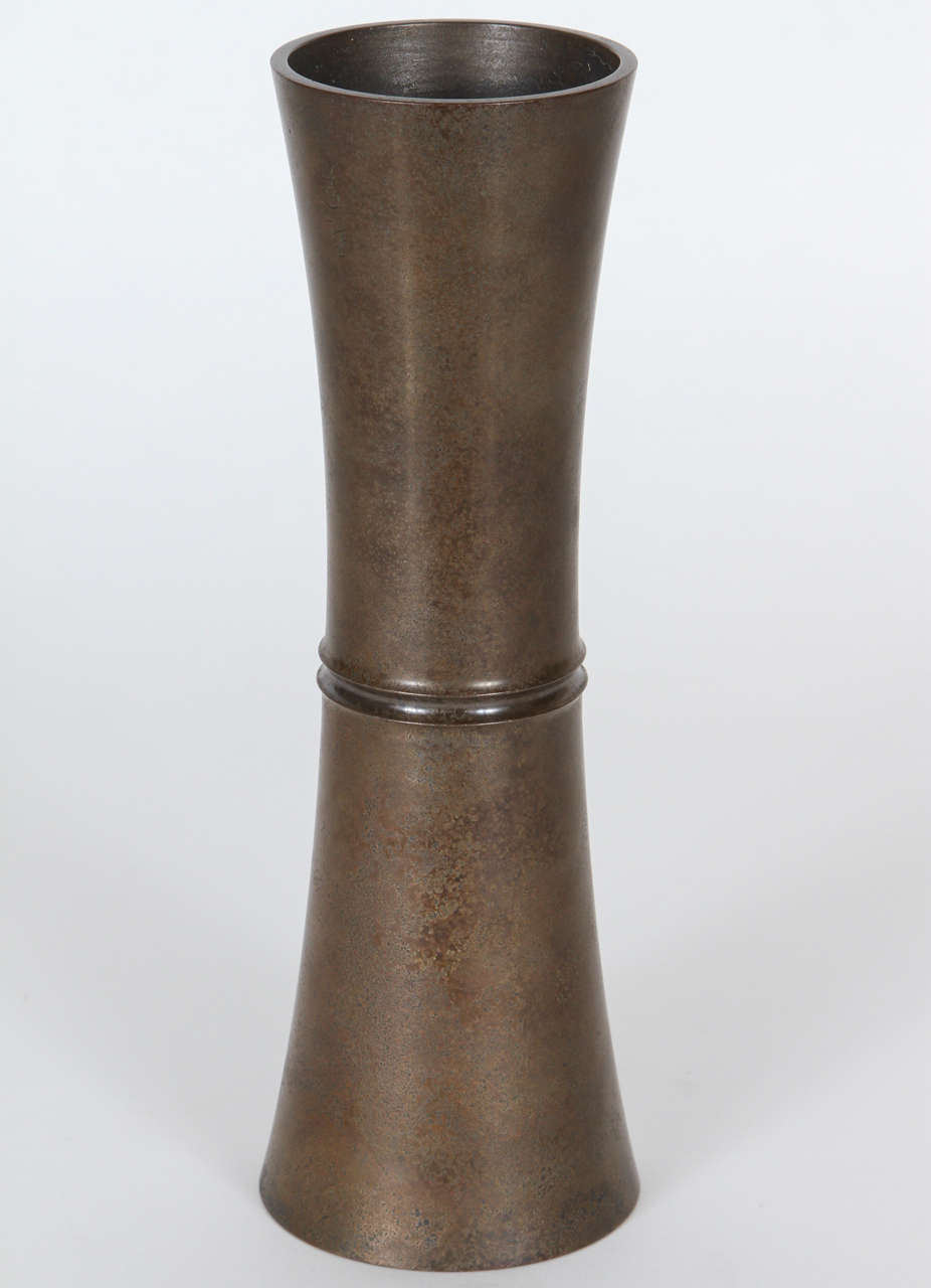An unusual reversible bronze vase with a subtly textured surface and a greenish-grey patina, with the artist's mark on the side.  