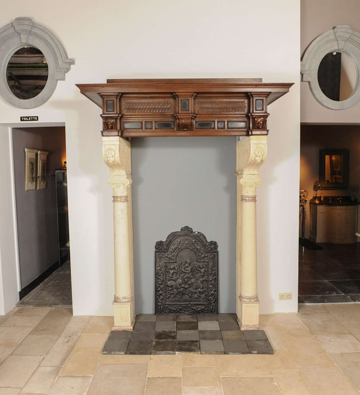 A Neo Renaissance fireplace, it's limestone legts with Corinthian columns and finely carved corbels. The oak and ebony parallel top with carved lions heads.