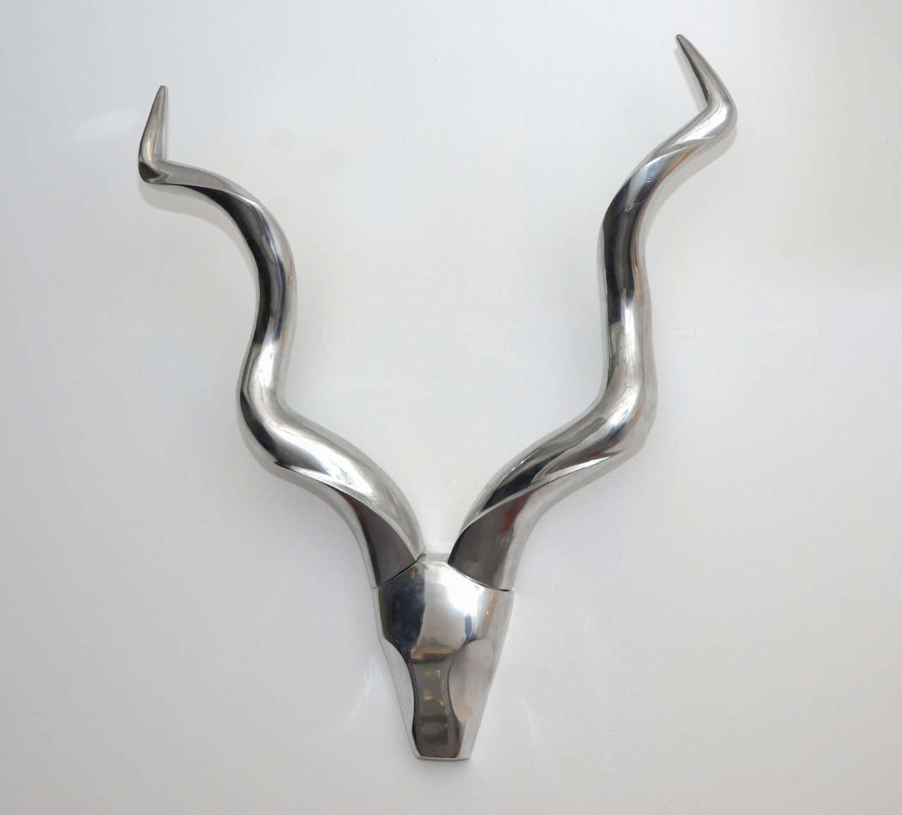 Large 1970s sculpture by Pierre David (not signed); represents a stylized animal skull with horns in brushed aluminum.
