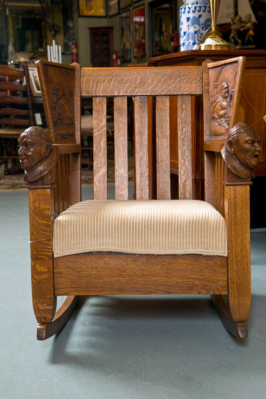Antique oak mission style settee and rocking chair with beautifully carved monk figures.The settee is approximately 67