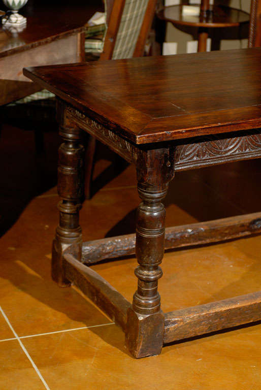 An early oak refectory table with carved detail on frieze, turned legs and stretcher. The top is from a later date. 

William Word Fine Antiques: Atlanta's source for antique interiors since 1956.