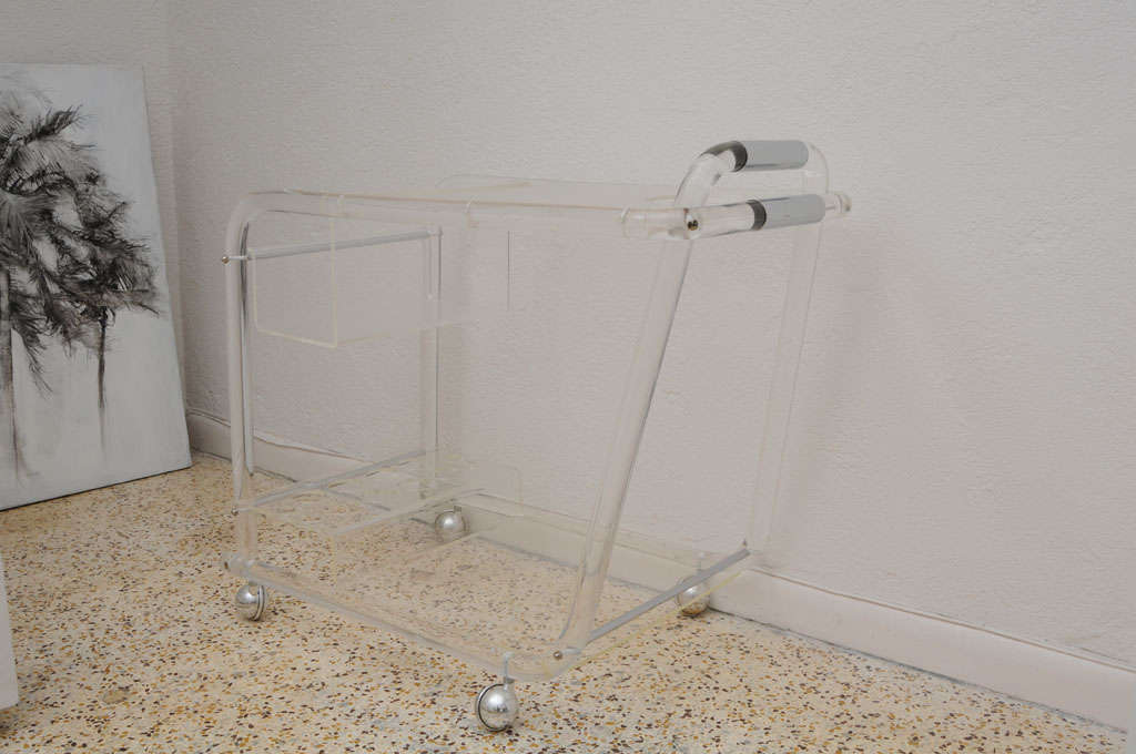 This piece is very much in the style of Charles Hollis Jones and was created in the 1970s. The upper section tray-top is in a pebbled texture to keep thing secure and an opening to hold an ice bucket. There is a recessed area to hold liquor bottles,