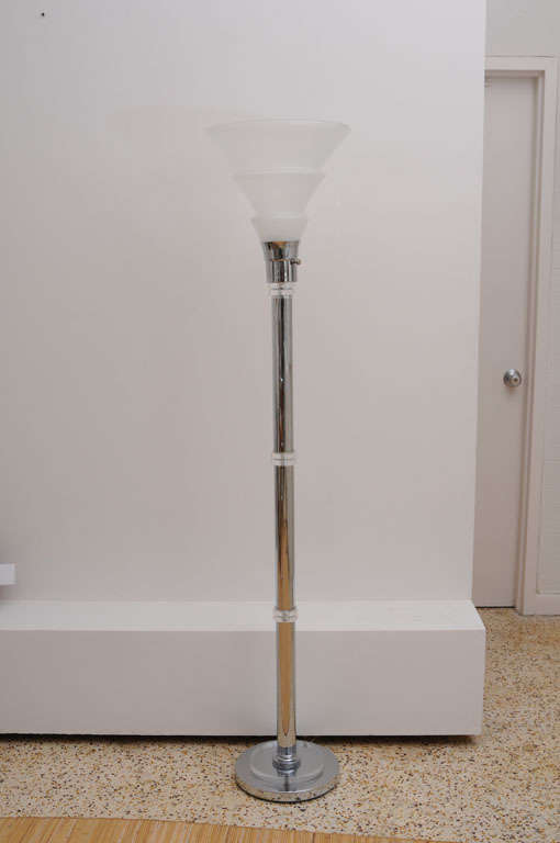 This polished chrome and frosted glass Art Deco style floor lamp embodies the style and movement of the period even though it dates from the 1980s.


