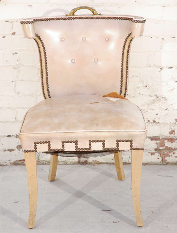Rare original Dorothy Draper designed scroll back klismos chair. Upholstered in original leather featuring a tufted back and brass greek key nailhead detailing.