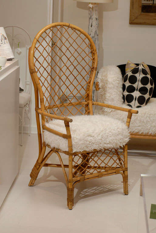* vintage rattan chairs 
* newly reupholstered in a faux fur
* legs curve further in back 
* original rattan 
* two chairs available