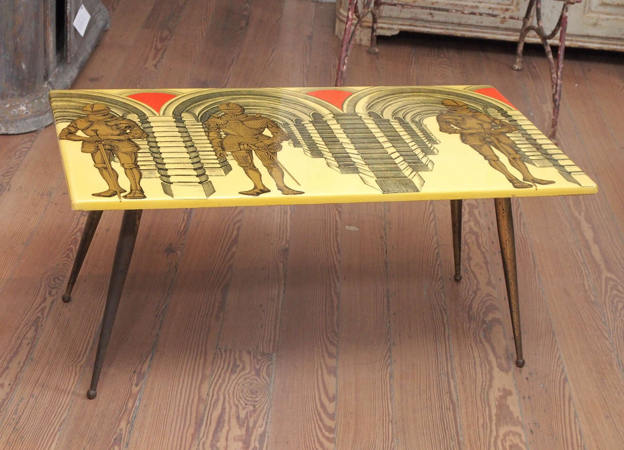 Metal and plantic Fornasetti coffee table depicting knights in armour.