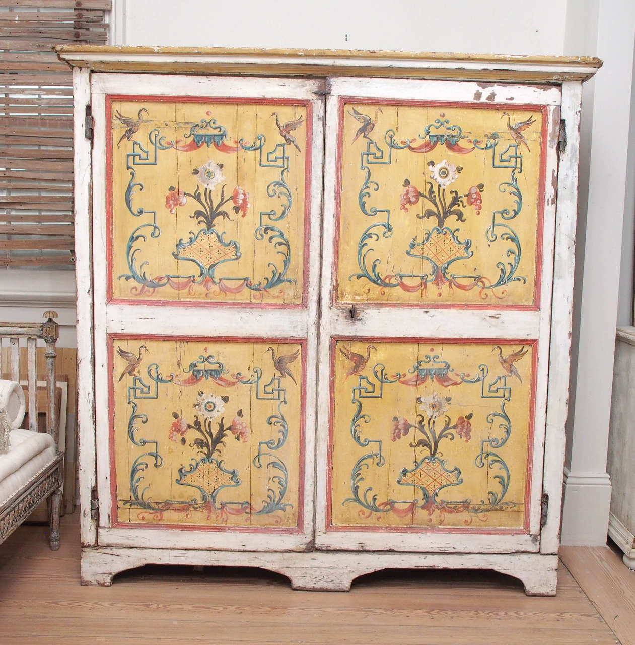 Charming 18th-century painted cupboard with panels depicting flowers and birds; three interior shelves.